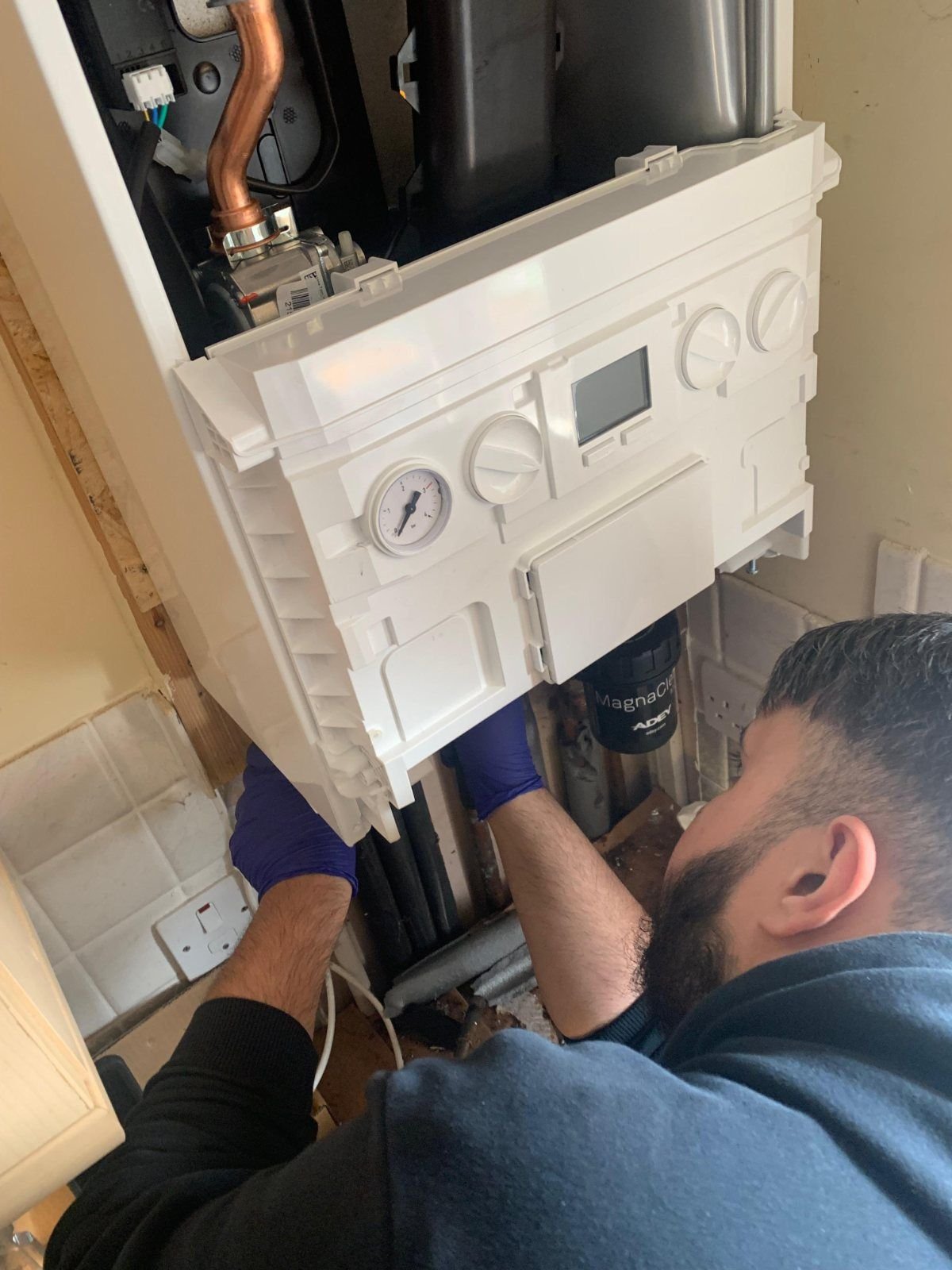 Direct Gas & Heating engineer servicing a boiler